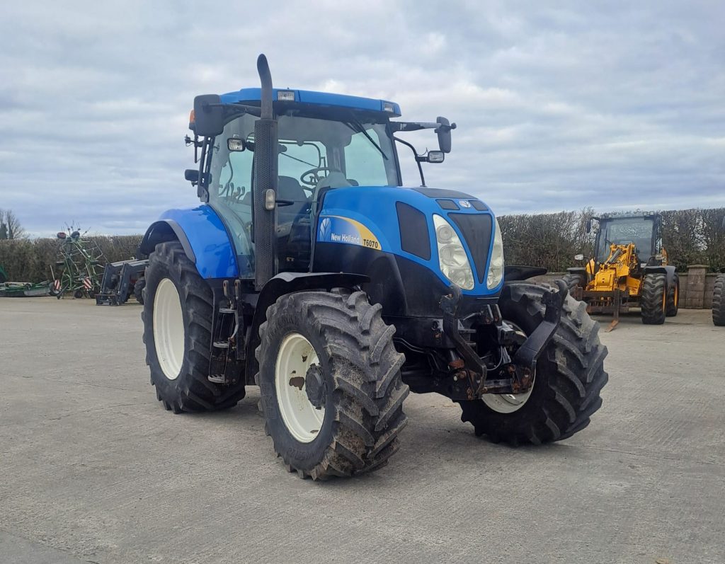 New Holland T6070 tractor viewed from the front-right side, showcasing its robust design and features.