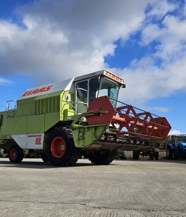 Front-right side view of the Claas Dominator 98S combine harvester, showcasing its large tires and advanced design.