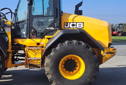 JCB yellow tractor displaying part of its left side.