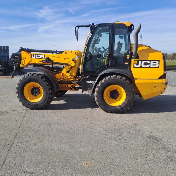 Side view of the JCB TM 320S, showcasing the left side of the tractor with its sturdy build and ergonomic design for improved functionality.