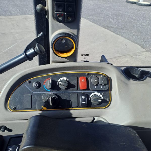 View of the JCB TM 320S cabin, focusing on the control panel located on the left side, with various buttons and switches for easy operation.
