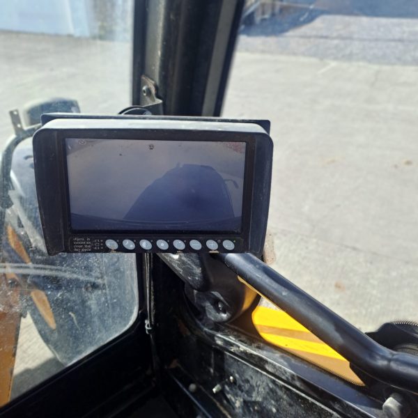 Inside the cabin of the JCB TM 320S, displaying the digital control panel on the right side, showcasing advanced controls and instruments.