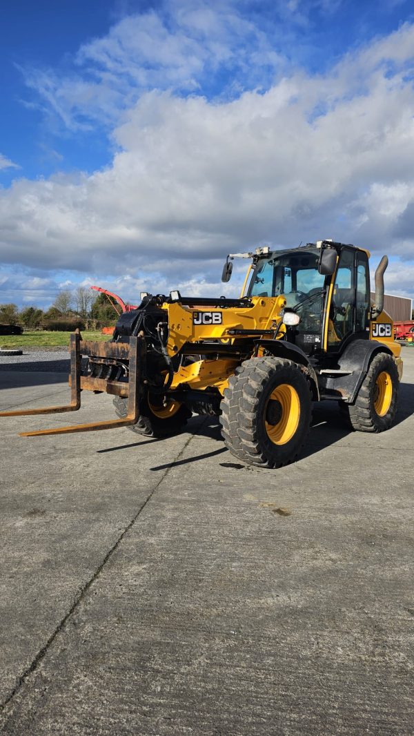 JCB TM 320S front-left side view, emphasizing its sturdy frame and powerful design.