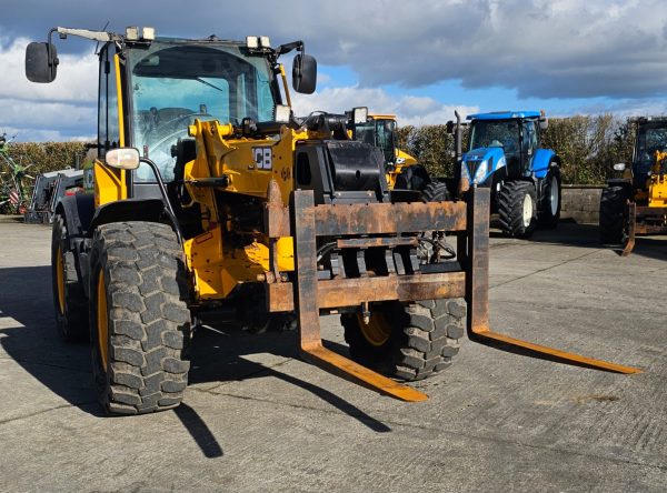 JCB TM 320S front-right side view, highlighting its robust construction and design features.
