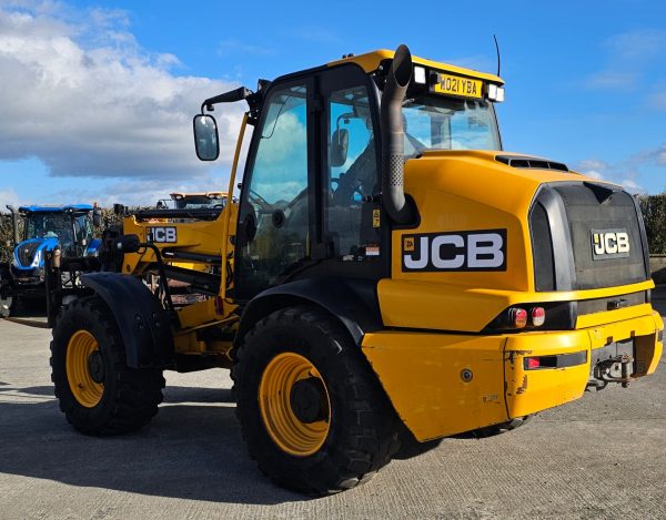 Back left-side view of the JCB TM 320S, showcasing its rear and side design features, including the left rear wheel and structural components.