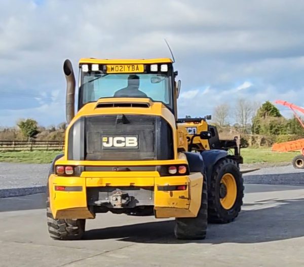 Backside view of the JCB TM 320S, showcasing its rear wheel, tow hook, and rear design features.