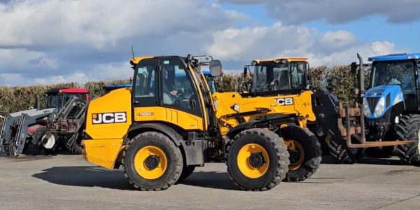 Right side view of the JCB TM 320S telehandler, highlighting its powerful build and durable design for agricultural tasks.