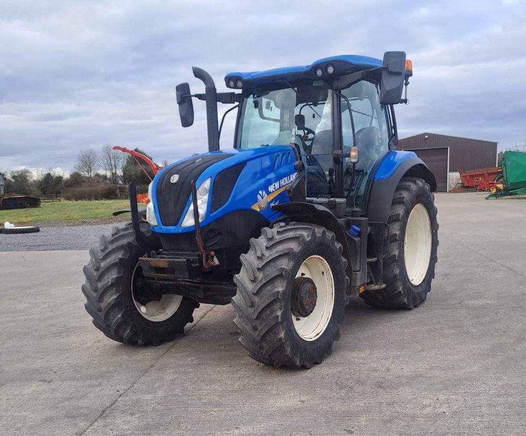 Front side diagonal view of the New Holland T6180 tractor, pointing towards the south-west, showcasing its strong design and high-performance features.