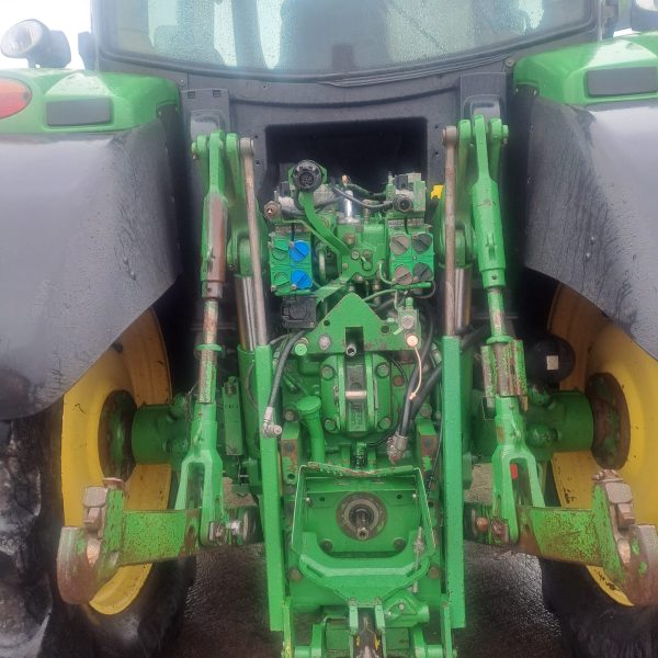 Close-up view of the back engine of a John Deere tractor, showcasing the machinery and components.