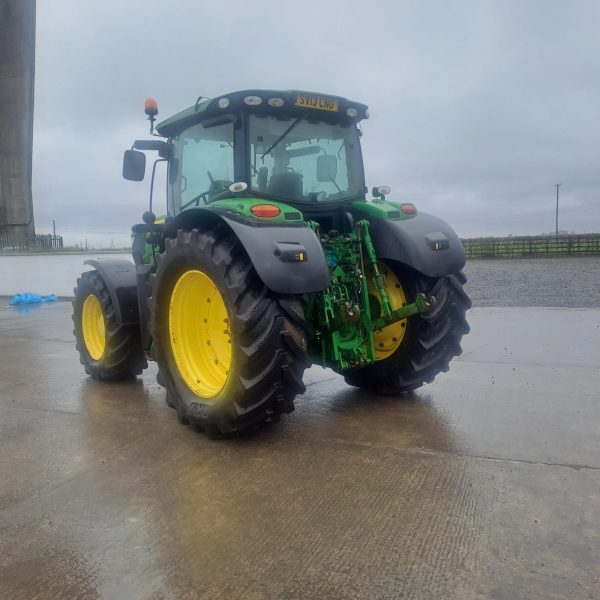 Back to front left view of a John Deere tractor, facing northwest, showcasing its rear and front design, with visible agricultural machinery features.