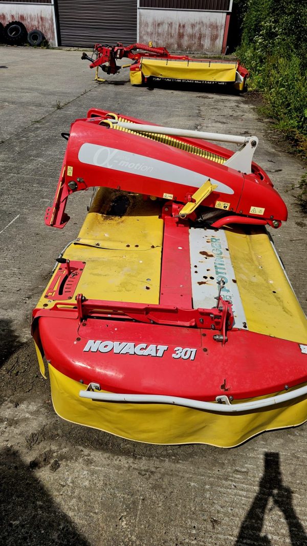 Left side view of the Pottinger Mower Novacat 301 10 Foot Front Mower, showcasing its design and agricultural features.