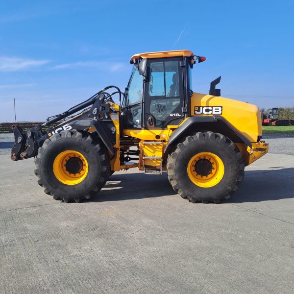 Side view of a JCB yellow tractor, with the front facing to the left, showcasing its design and agricultural machinery features.