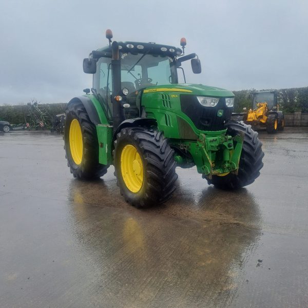 Front view of a John Deere tractor pointing southeast, showcasing its strong design and agricultural capabilities.
