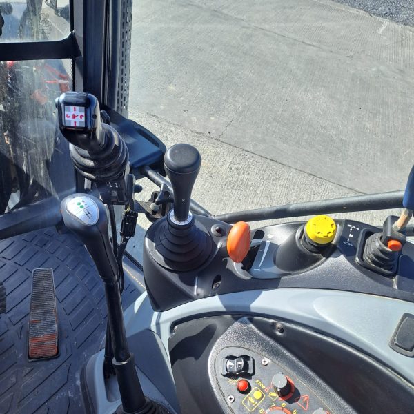 Close-up of the tractor gears inside the cabin, showcasing the machinery controls and operational components.