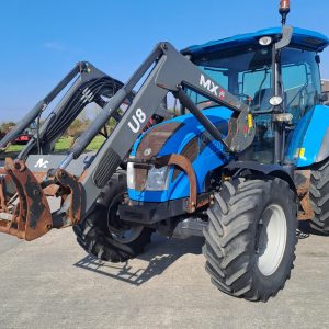 Blue U8 MX tractor in a field, with a bright blue sky in the background, symbolizing agricultural machinery and farming operations.