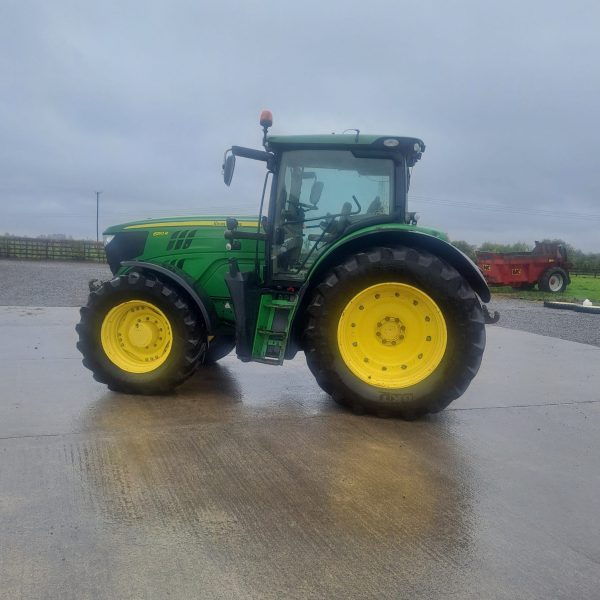 Left side view of a John Deere tractor, highlighting its design, wheels, and agricultural machinery features.