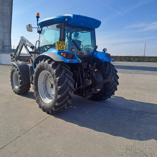 Backside diagonal view of a blue U8 MX tractor from a northwest angle, highlighting its rear design and agricultural features.