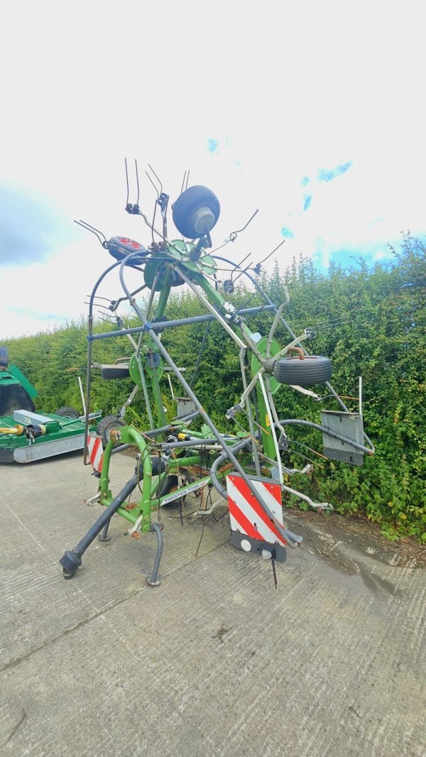 Side view of a Fendt Twister 7706, pointing diagonally to the left, showcasing the agricultural machinery and features.