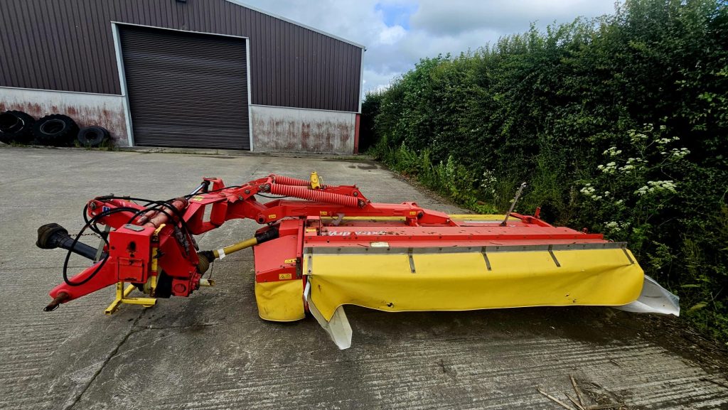 Left side view of the Pottinger Novacat 305 10 Foot Conditioner Mower, showcasing its design and agricultural features.